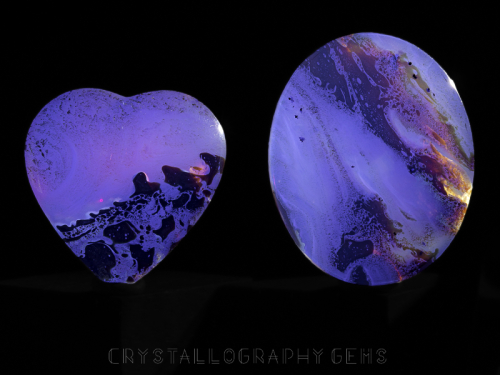 Blue Indonesian Amber fossil heart carving and palm stone under UV black light