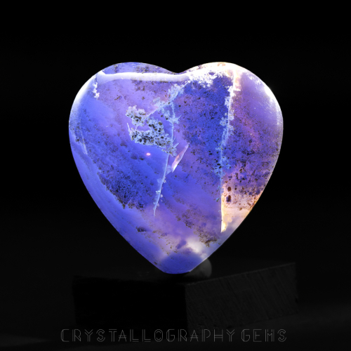 Blue Indonesian Amber fossil heart carving under UV black light